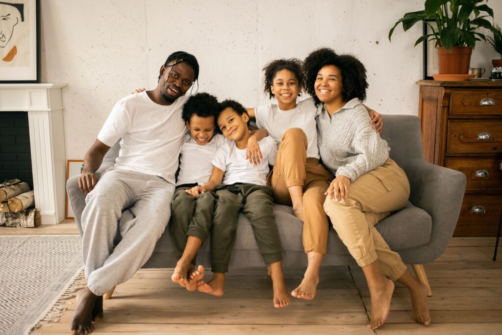 Colorado family standing outside their home, illustrating the opportunity and stability created through affordable homeownership.